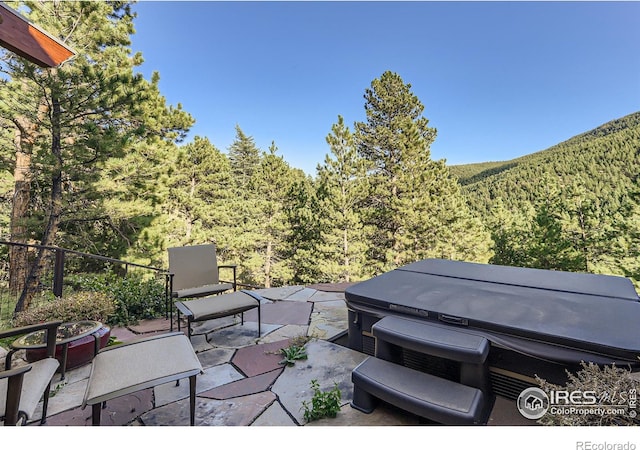 2307 Magnolia Dr, Nederland, CO 80466 - view of patio featuring a hot tub and a forest view