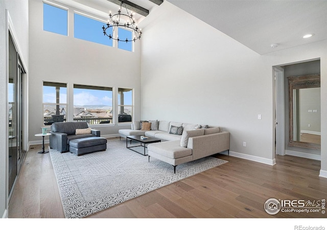 3295 Heron Lakes Pkwy, Berthoud, CO 80513 - living area with a towering ceiling, wood finished floors, baseboards, recessed lighting, and a chandelier