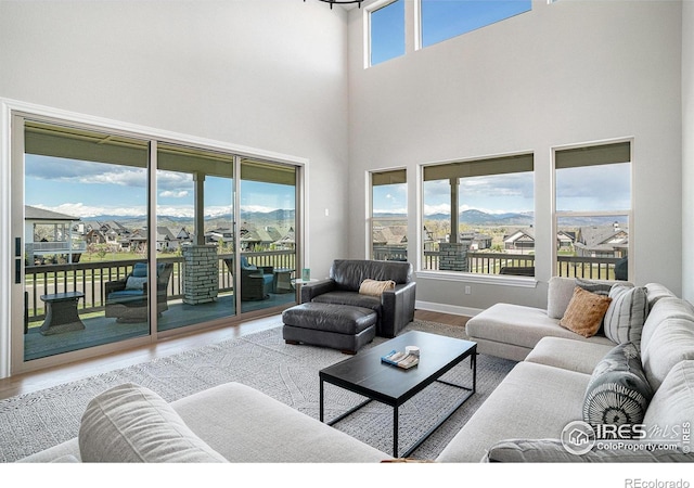 3295 Heron Lakes Pkwy, Berthoud, CO 80513 - living area featuring a towering ceiling and wood finished floors