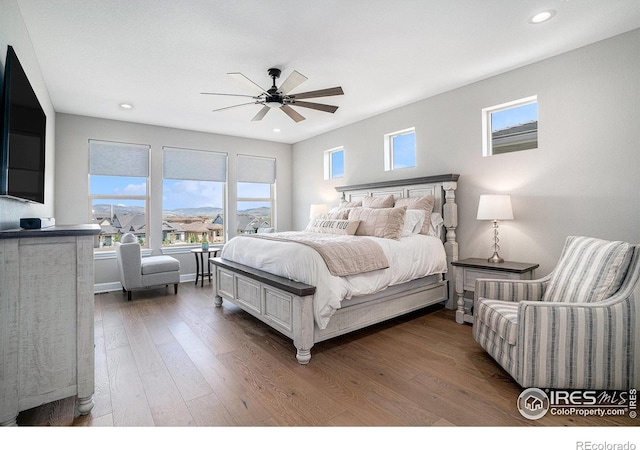 3295 Heron Lakes Pkwy, Berthoud, CO 80513 - bedroom featuring recessed lighting, multiple windows, and wood finished floors
