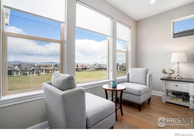 3295 Heron Lakes Pkwy, Berthoud, CO 80513 - sitting room with plenty of natural light and wood finished floors