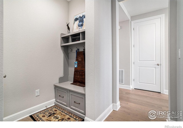 3295 Heron Lakes Pkwy, Berthoud, CO 80513 - mudroom with baseboards, visible vents, a textured wall, and light wood-style floors
