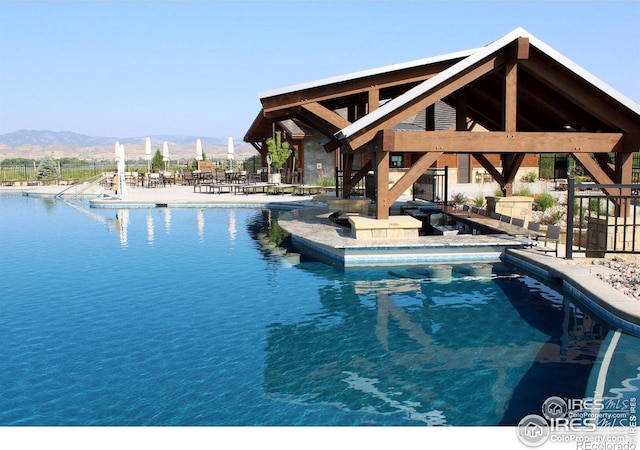 3295 Heron Lakes Pkwy, Berthoud, CO 80513 - pool featuring a mountain view and a patio area
