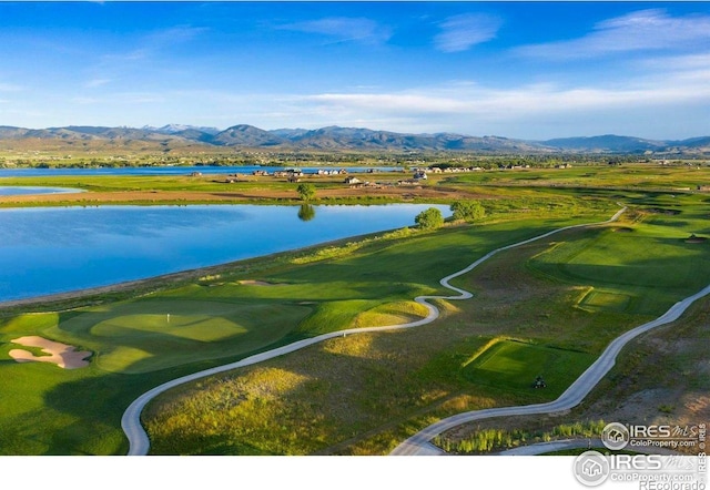 3295 Heron Lakes Pkwy, Berthoud, CO 80513 - drone / aerial view featuring golf course view and a water and mountain view