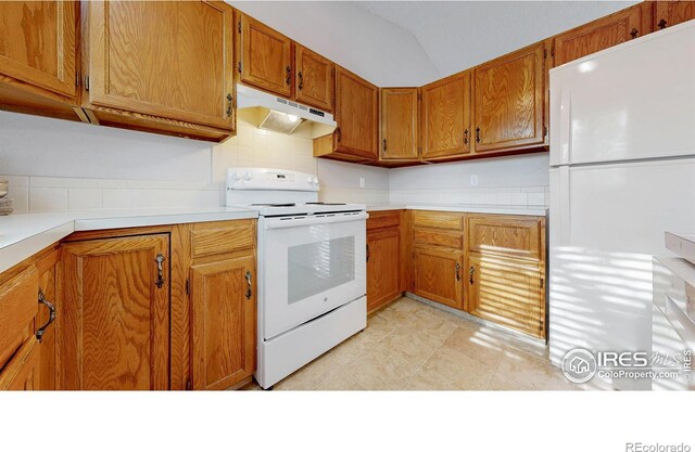 kitchen featuring brown cabinets, white appliances, light countertops, tasteful backsplash, and under cabinet range hood