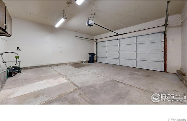 garage featuring baseboards and a garage door opener
