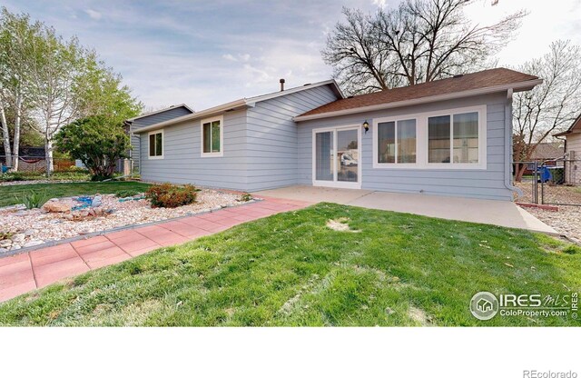 back of property with a patio area, fence, and a yard