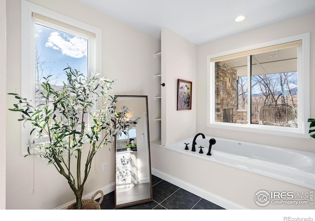 full bathroom featuring a bath, a healthy amount of sunlight, and tile patterned flooring