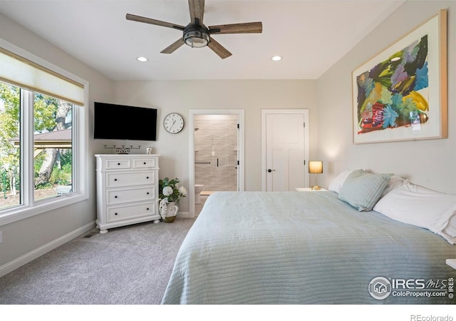 bedroom featuring baseboards, light carpet, recessed lighting, and connected bathroom