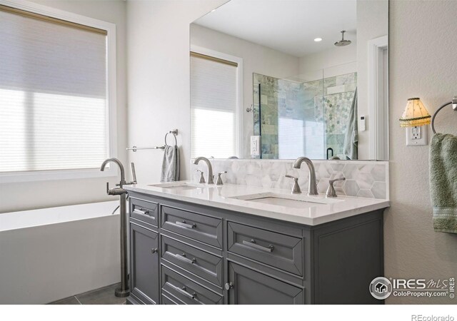 full bath featuring plenty of natural light, a sink, and a shower stall