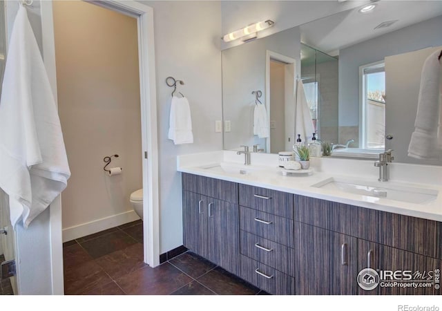 1025 Neon Forest Cir, Longmont, CO 80504 - full bath featuring toilet, double vanity, baseboards, and tile patterned floors