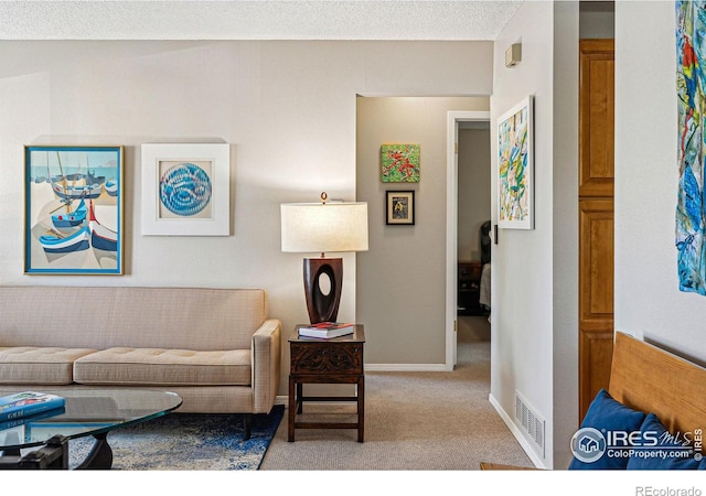 living room featuring visible vents, carpet, and baseboards