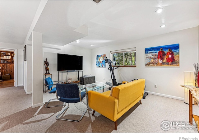 carpeted living area with recessed lighting and baseboards