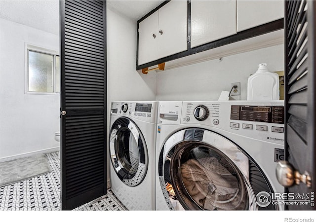 washroom featuring cabinet space and washing machine and dryer