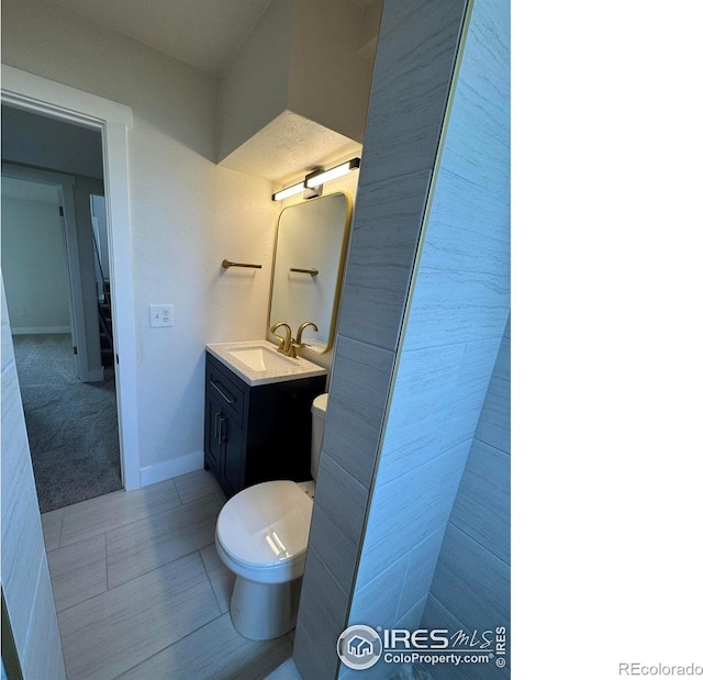 2221 E 84th Ave, Denver, CO 80229 - bathroom featuring vanity, toilet, baseboards, and tile patterned floors