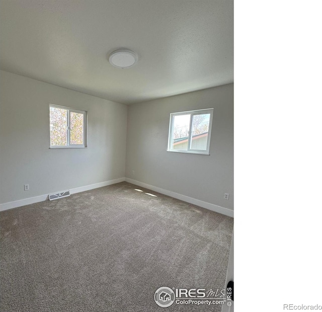2221 E 84th Ave, Denver, CO 80229 - unfurnished room featuring plenty of natural light, baseboards, and carpet flooring
