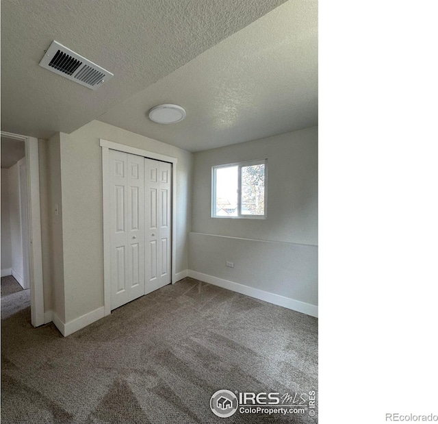 2221 E 84th Ave, Denver, CO 80229 - unfurnished bedroom with carpet flooring, a textured ceiling, baseboards, and a closet