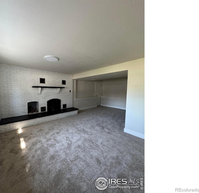 2221 E 84th Ave, Denver, CO 80229 - unfurnished living room featuring carpet floors, a textured ceiling, and baseboards