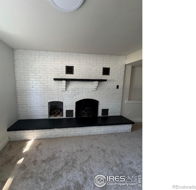 2221 E 84th Ave, Denver, CO 80229 - unfurnished living room featuring carpet, a brick fireplace, and baseboards