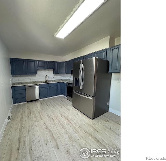 2221 E 84th Ave, Denver, CO 80229 - kitchen featuring appliances with stainless steel finishes, a sink, light countertops, and light wood-style flooring