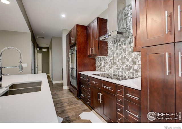 2624 S Race St, Denver, CO 80210 - kitchen featuring wall chimney range hood, a sink, stainless steel double oven, black electric stovetop, and decorative backsplash