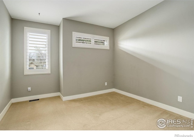 2624 S Race St, Denver, CO 80210 - spare room featuring healthy amount of natural light, carpet flooring, and baseboards