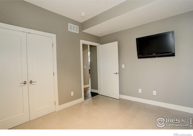 2624 S Race St, Denver, CO 80210 - unfurnished bedroom featuring baseboards, light tile patterned floors, and a closet
