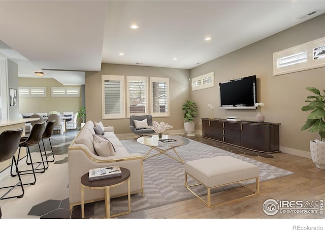 2624 S Race St, Denver, CO 80210 - living room with recessed lighting, wood finished floors, and baseboards