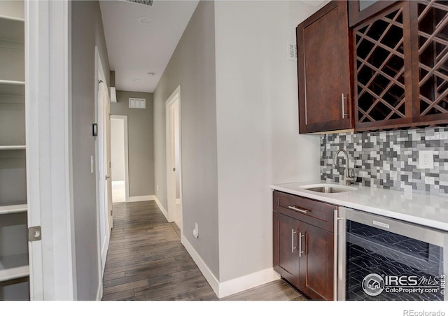 2624 S Race St, Denver, CO 80210 - indoor wet bar with beverage cooler, dark wood-type flooring, tasteful backsplash, and baseboards