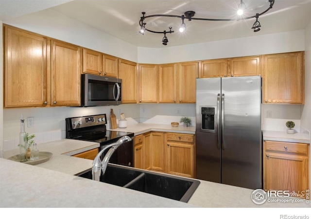 2120 Timber Creek Dr Unit H4, Fort Collins, CO 80528 - kitchen with track lighting, light countertops, a sink, and stainless steel appliances