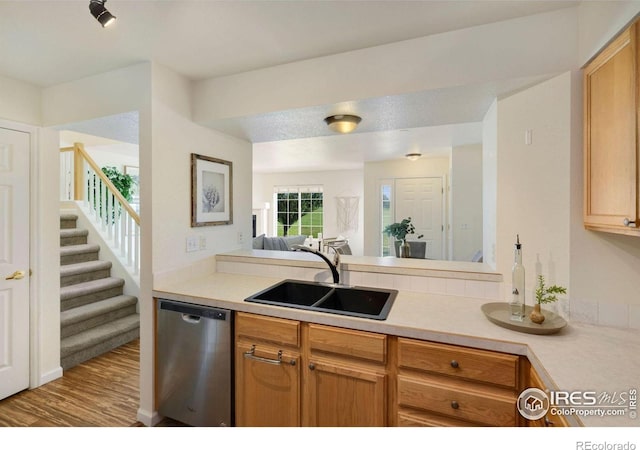 2120 Timber Creek Dr Unit H4, Fort Collins, CO 80528 - kitchen featuring a sink, light countertops, wood finished floors, and dishwasher