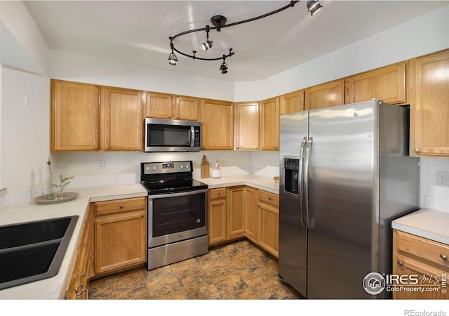 2120 Timber Creek Dr Unit H4, Fort Collins, CO 80528 - kitchen with light countertops, a sink, stone finish flooring, and stainless steel appliances