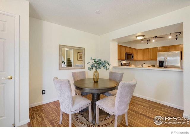 2120 Timber Creek Dr Unit H4, Fort Collins, CO 80528 - dining room featuring baseboards, light wood-style flooring, and track lighting