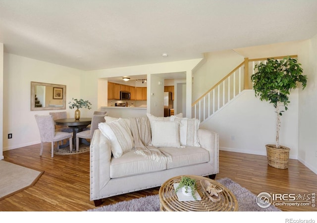 2120 Timber Creek Dr Unit H4, Fort Collins, CO 80528 - living room with baseboards, stairs, and wood finished floors