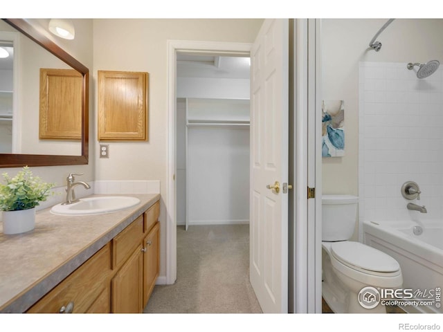 bathroom featuring vanity, tub / shower combination, and toilet