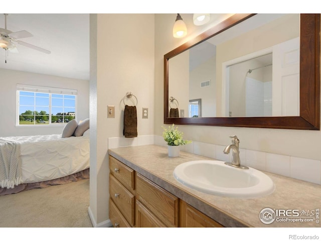 ensuite bathroom featuring vanity, a ceiling fan, ensuite bath, and visible vents
