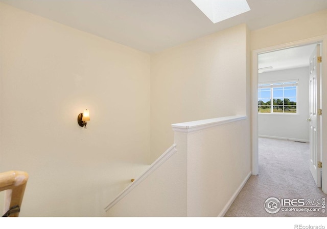 2120 Timber Creek Dr Unit H4, Fort Collins, CO 80528 - hall with light colored carpet, a skylight, an upstairs landing, and baseboards