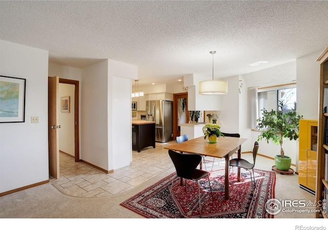 6611 Lakeview Dr, Boulder, CO 80303 - dining room featuring baseboards, a textured ceiling, and light colored carpet