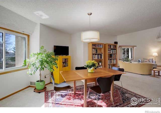 6611 Lakeview Dr, Boulder, CO 80303 - carpeted dining area featuring baseboards, a textured ceiling, and visible vents