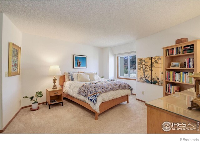6611 Lakeview Dr, Boulder, CO 80303 - bedroom featuring a textured ceiling, baseboards, and light colored carpet