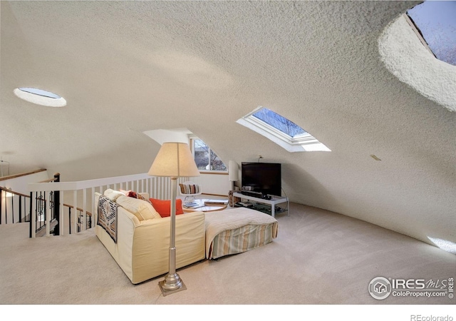 6611 Lakeview Dr, Boulder, CO 80303 - carpeted living area featuring lofted ceiling with skylight and a textured ceiling