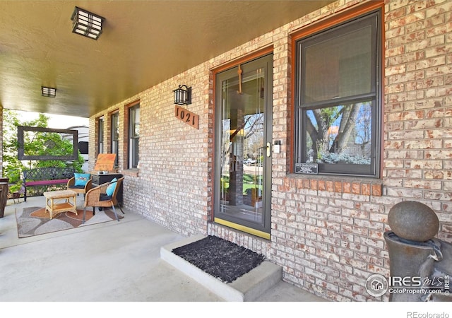 1021 Pinyon Dr, Windsor, CO 80550 - entrance to property with a porch and brick siding