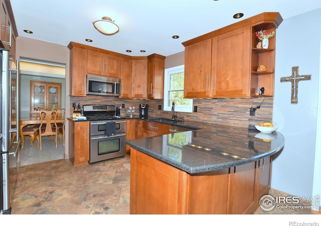 1021 Pinyon Dr, Windsor, CO 80550 - kitchen with a sink, backsplash, stainless steel appliances, and a peninsula
