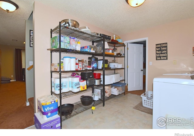 1021 Pinyon Dr, Windsor, CO 80550 - laundry room featuring a textured ceiling, laundry area, and washer and clothes dryer