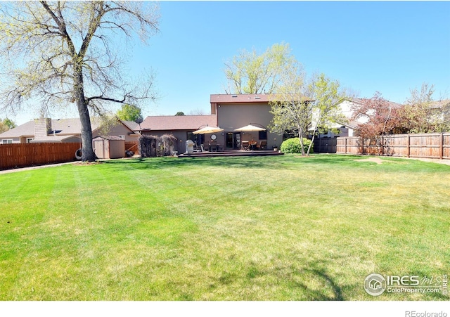 1021 Pinyon Dr, Windsor, CO 80550 - view of yard featuring an outdoor structure, a fenced backyard, and a shed