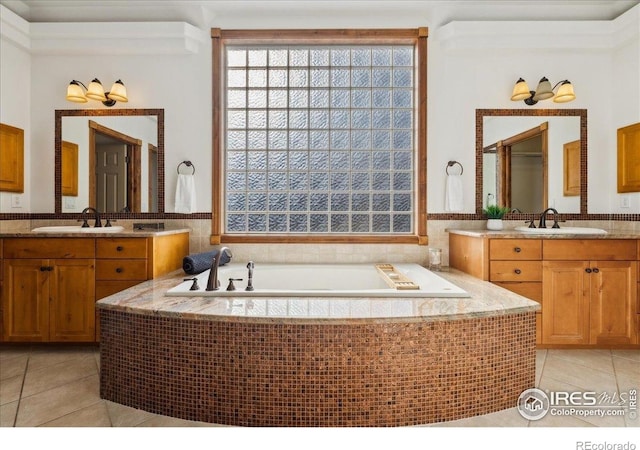 full bathroom featuring tile patterned floors, a wealth of natural light, and a sink