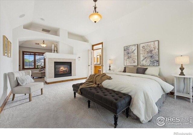 bedroom with carpet flooring, baseboards, visible vents, and a glass covered fireplace