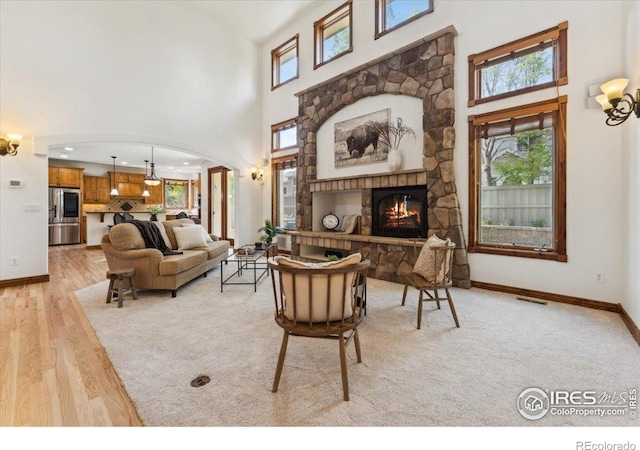living area with visible vents, plenty of natural light, and a high ceiling