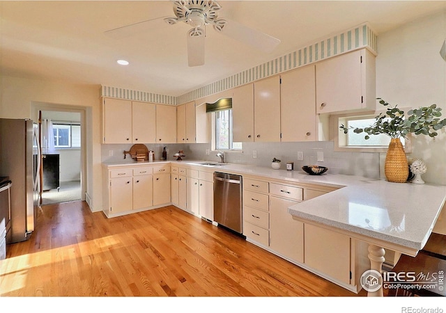 821 36th Ave, Greeley, CO 80634 - kitchen featuring stainless steel appliances, light countertops, cream cabinetry, and decorative backsplash