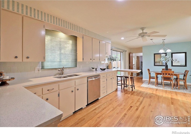 821 36th Ave, Greeley, CO 80634 - kitchen with stainless steel dishwasher, a sink, light wood-style flooring, tasteful backsplash, and recessed lighting